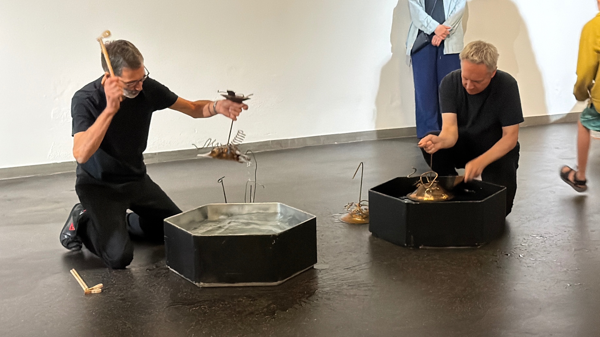 Exhibition view, vernissage — Pit Gutmann and Matthias Brodbeck playing the water sound objects, oxyd Winterthur